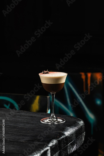 Classic espresso martini alcoholic cocktail with coffee at the dark atmosphere of the bar