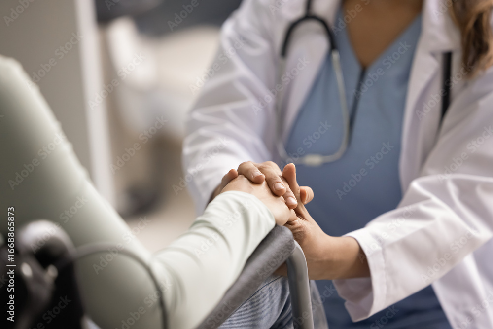 Fototapeta premium Sympathetic doctor giving comfort, psychological help to woman with disability