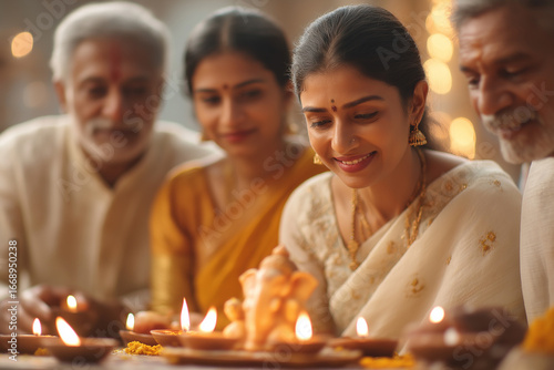 Family sitting around Ganesh idol while performing prayer ritual
