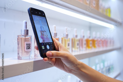 Hand Scanning QR Code on Skincare Bottle with Smartphone
