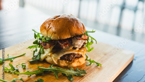 A towering double-deck bacon cheeseburger with juicy, rare beef patties, melted cheese, and crispy bacon. Perfect for gourmet burger spots, food blogs, and indulgent culinary content.