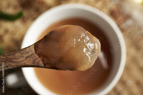 Homemade flax seed gel on a wooden spoon - ingredient for natural diy shampoo. Alternative haircare, no poo.