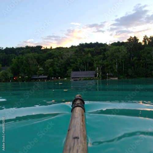 Turquoise lake with wooden oar