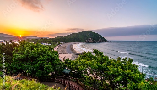 Sunrise over tranquil beach, hills and ocean