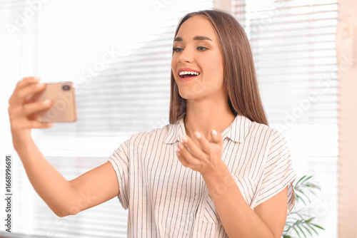 Young woman video chatting ...