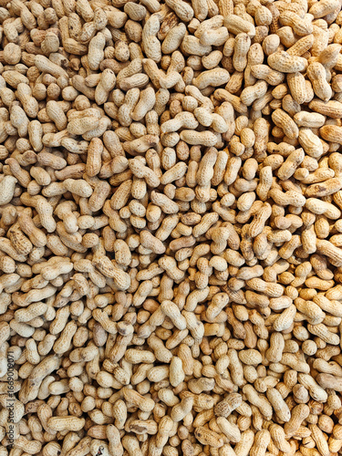 Peanuts spread across a surface ready for packaging and sale at a local market in the afternoon light