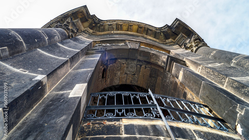 Detail view of the portal of a historic building near the Frauenkirche in Dresden, photographed from a low angle perspective.