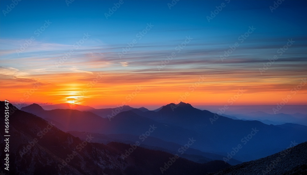 Fototapeta premium sunset over the mountains with orange and blue hues