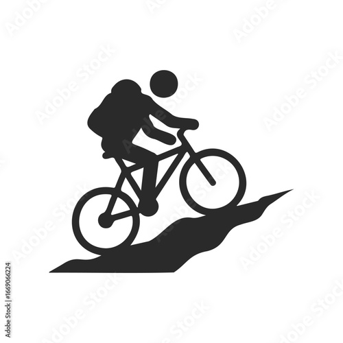 Silhouette of cyclist climbing hill on mountain bike