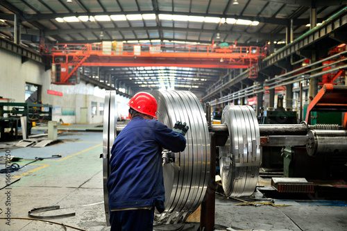 Workers on the production line of the strip steel coil factory are working