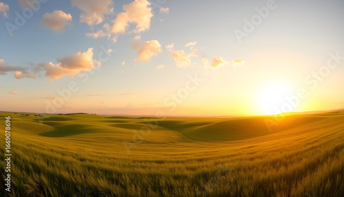 A scenic view of rolling green hills under a blue sky with fluffy clouds at sunset.