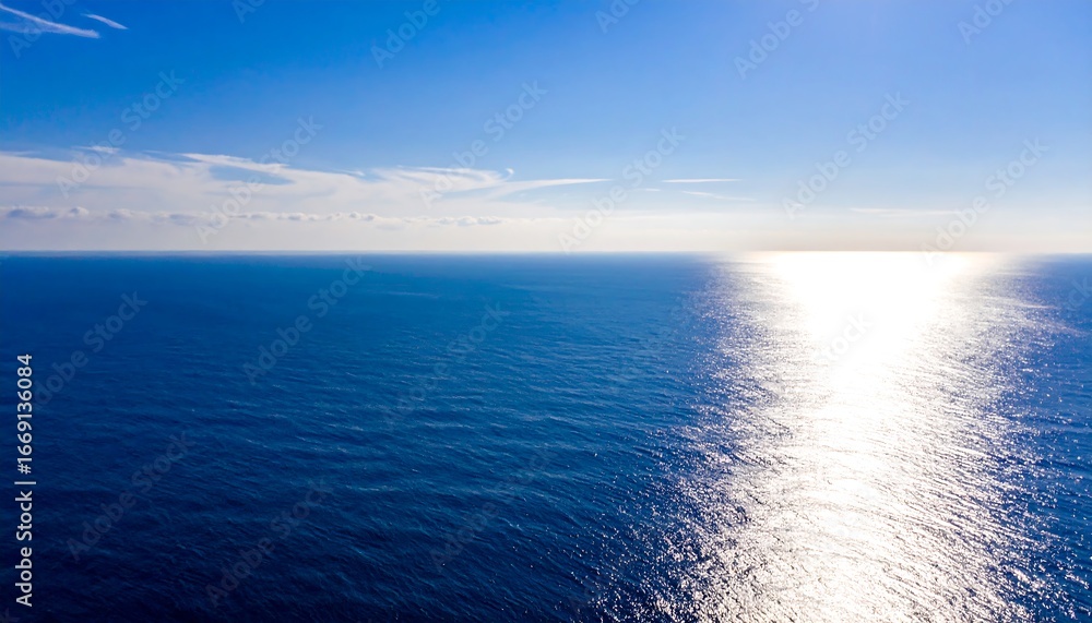 Fototapeta premium Vast ocean stretches under a vibrant sky