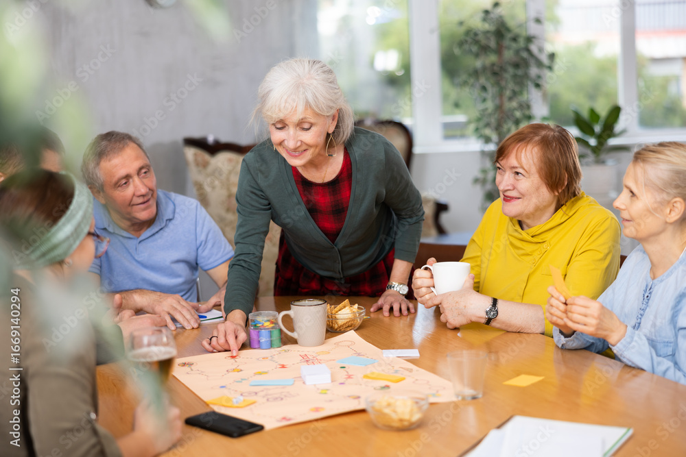 Fototapeta premium Group of senior friends at home, playing board games