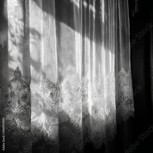 A white curtain with lace trim is hanging in front of a window