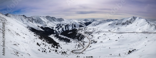 Breathtaking winter snow beauty of Loveland Pass, Colorado. Mountains and winding roads adventure and exploration. Nature's majesty with picturesque photo for travel, outdoor, or landscape project