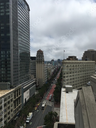 Foggy Downtown Vista: A top-down shot of a dense urban environment on a grey day, with buildings disappearing into the mist, capturing the quintessential San Francisco weather.