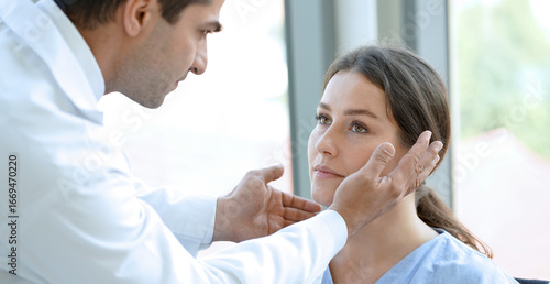 Bild auf Leinwand Doctor is examining the vision of a young female patient's eyes.