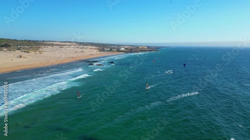 Aerial view following a kitesurfer on a great day perfect for windsurfing and kitesurfing on the splendid Guincho beach in Cascais,Portugal