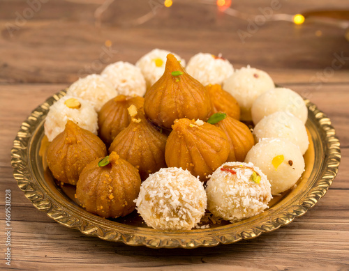 Traditional Indian Sweets Platter with Modaks and Ladoos, Festive Delicacies for Celebrations and Festivals.