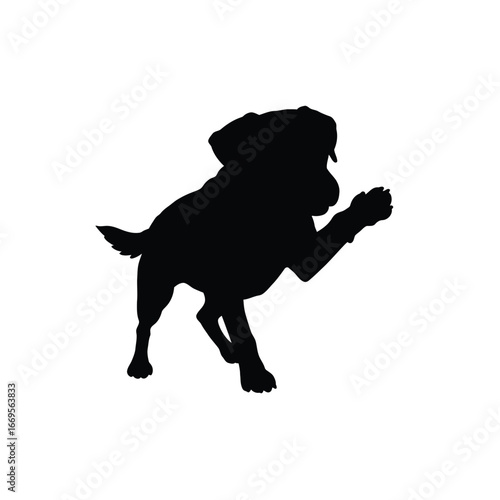 A black silhouette of a dog running or jumping with one paw raised high