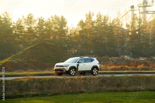 Obraz na płótnie Scenic drive with SUV in sunlight