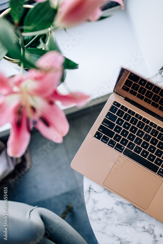 Rose Gold Laptop with Pink Lilies on Marble Table