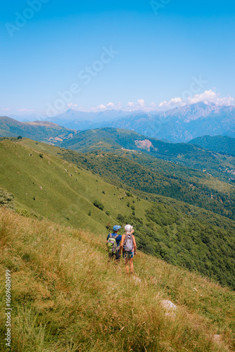 Hikers resting at scenic viewpoint on the Monte Palanzone, Como