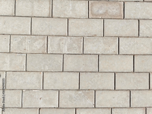 Gray concrete pavers arranged in a uniform pattern  suitable for various outdoor spaces and landscaping projects