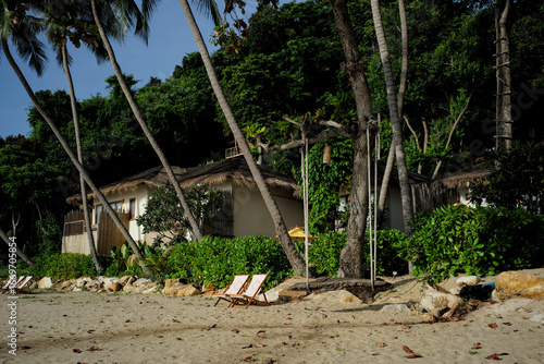 Vacancy couple of beach benches on the beach in front of the room in Bali style