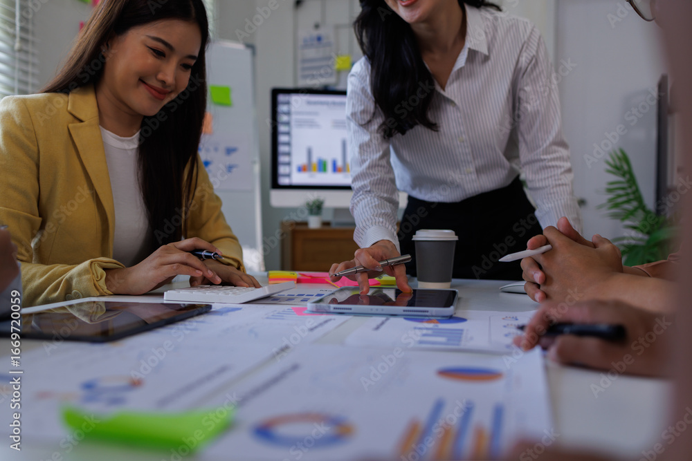 Fototapeta premium Corporate accountant Asian team use accounting software on laptop to calculate and maximize tax refund and improve financial performance base on financial data, business accounting . 