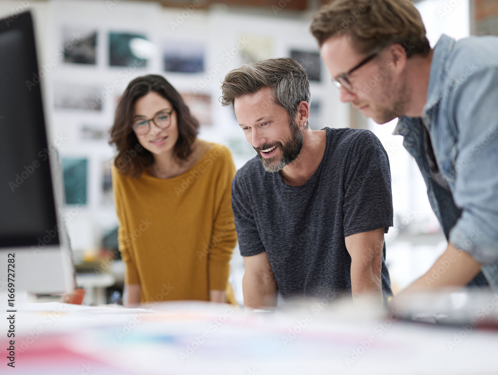 Obraz premium Creative team brainstorming ideas. Collaboration in a modern office setting, reviewing designs. Use for teamwork, business strategy, or design concepts.