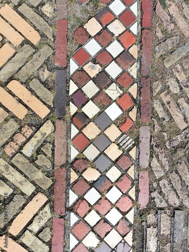 Close-up detail of bright colored brick and tile pavers laid out in contrasing geometric patterns