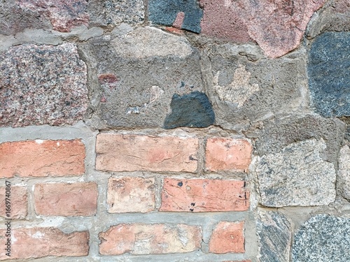 Colorful brick and stone masonry with contrasting shapes and pastel colors