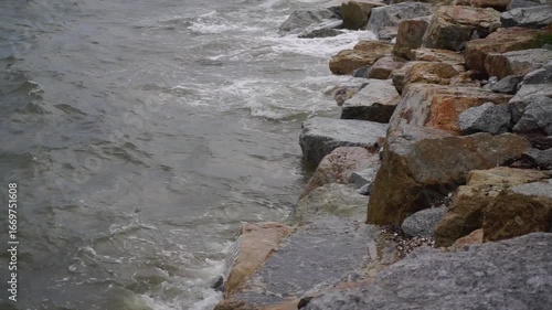 Close up shot of sea waves crashing against rock