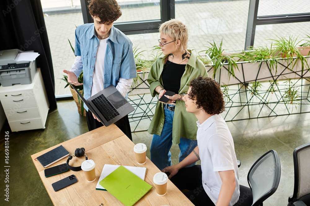 Fototapeta premium Collaboration among young professionals in a vibrant office workspace during a busy workday