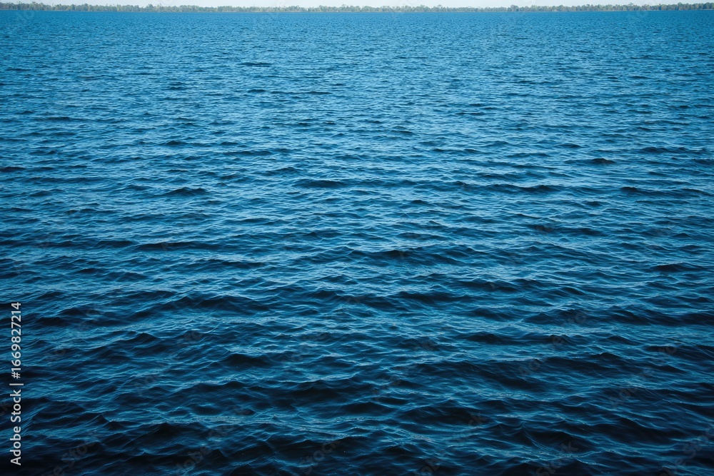 Fototapeta premium Calm, deep blue water surface, rippled texture