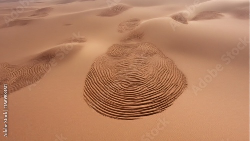 Circular ripple sand formations create a mesmerizing pattern in a desert landscape