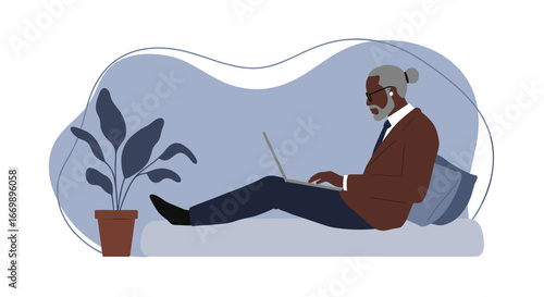 A stylish senior man works comfortably on his laptop from home, embodying modern remote work and a balanced lifestyle.