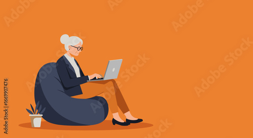 Senior woman focused on her laptop while relaxing on a beanbag. Highlights remote work, learning, and active digital engagement for older adults.