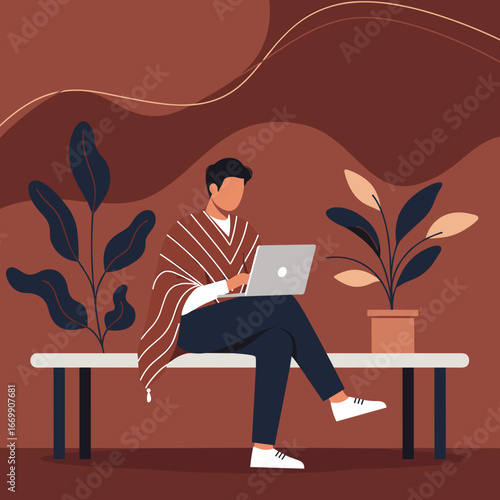 Young man wearing a poncho works remotely on his laptop in a cozy, modern indoor setting with plants, reflecting freelance lifestyle and digital connectivity.