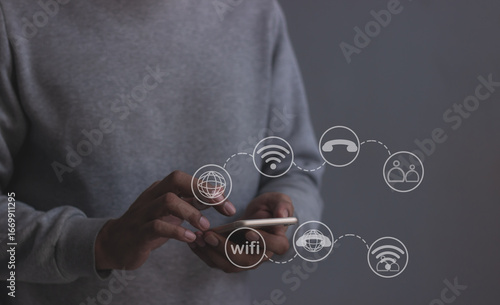 Young man hand using smartphone with to Interconnect, Interconnected Concept; People connect via wireless internet in a world of digital technology and communications that connect