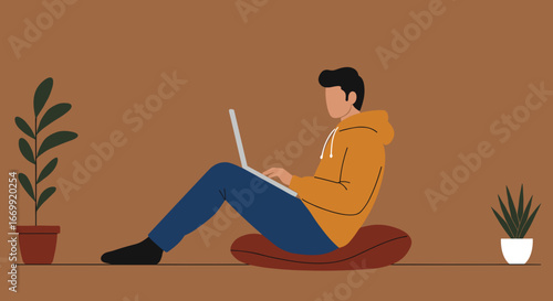 A young man comfortably works from home on his laptop, embodying remote productivity and a modern lifestyle. Ideal for business, education, or technology themes.