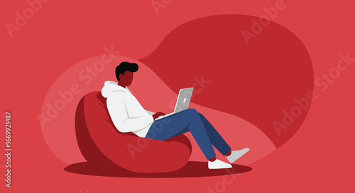 Young person casually working or studying on a laptop while relaxing on a comfortable bean bag chair at home. Ideal for remote work, education, or digital lifestyle concepts.