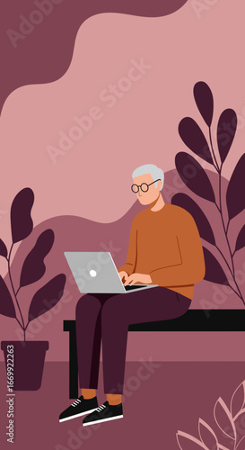 Senior man with glasses focused on working or learning on his laptop in a relaxed, modern indoor setting with plants, showcasing digital engagement.