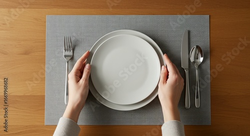 Plate, fork, spoon, and knife placed on a place mat