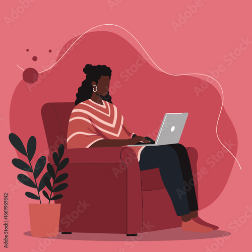 An African American woman comfortably works from home on her laptop in an armchair. Ideal for remote work, online learning, freelancing, and digital lifestyle concepts.