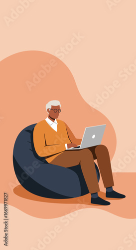 Elderly man comfortably uses a laptop on a bean bag, embracing modern senior lifestyle, digital learning, and remote connectivity.