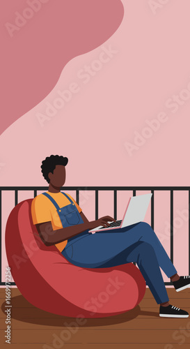 Young person working remotely on a laptop, comfortably seated on a beanbag chair on a balcony. Ideal for modern lifestyle, flexible work, and online education concepts.
