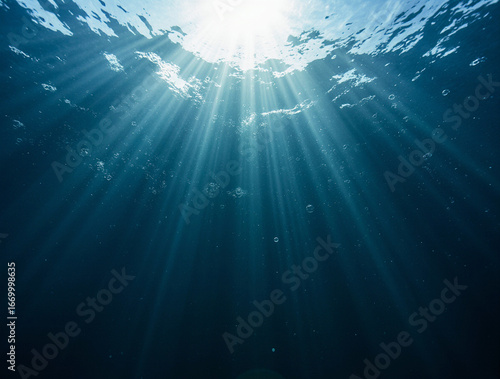 dark sea background, ocean depths and soft rays of light through the water