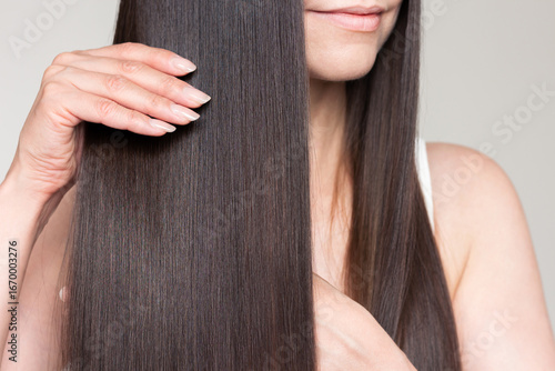 Photos Young caucasian beautiful brunette woman with smooth shiny brown and straight long hair after keratin straightening